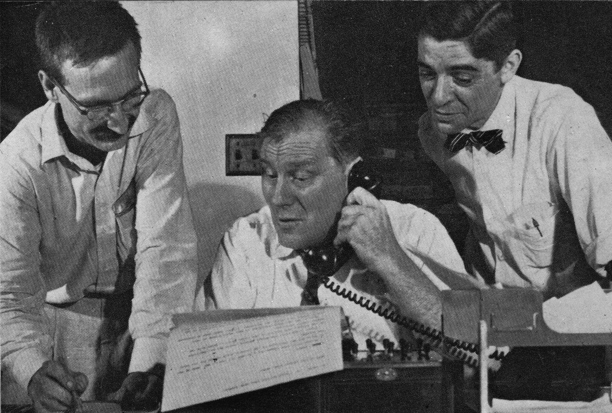 Three reporters at typewriter