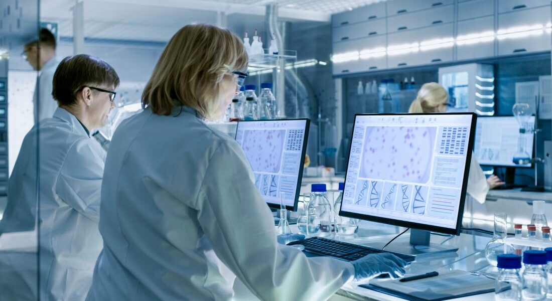 Researcerhs standing at computer screens