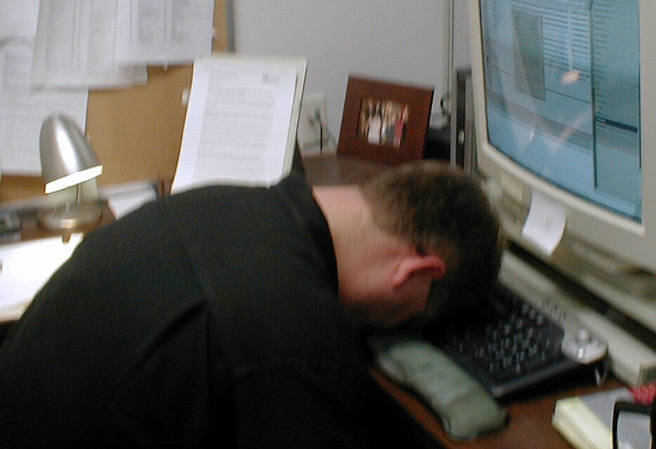 Man slumped over computer