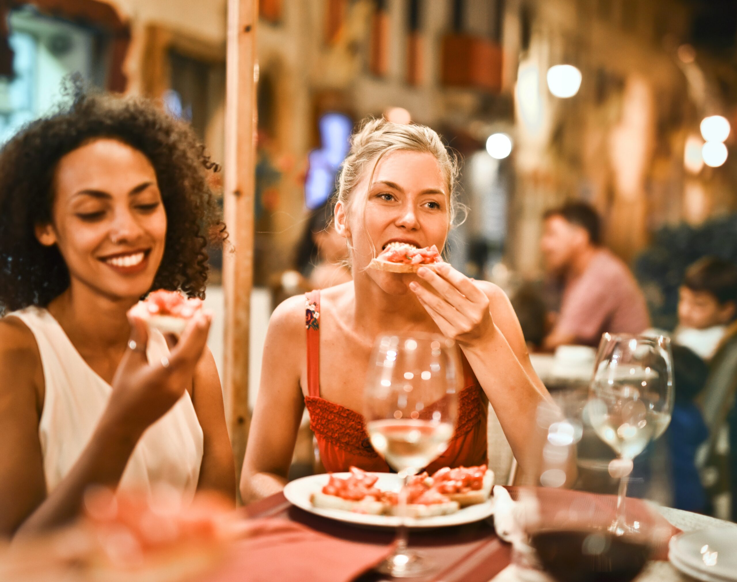 two women eating brushcetta